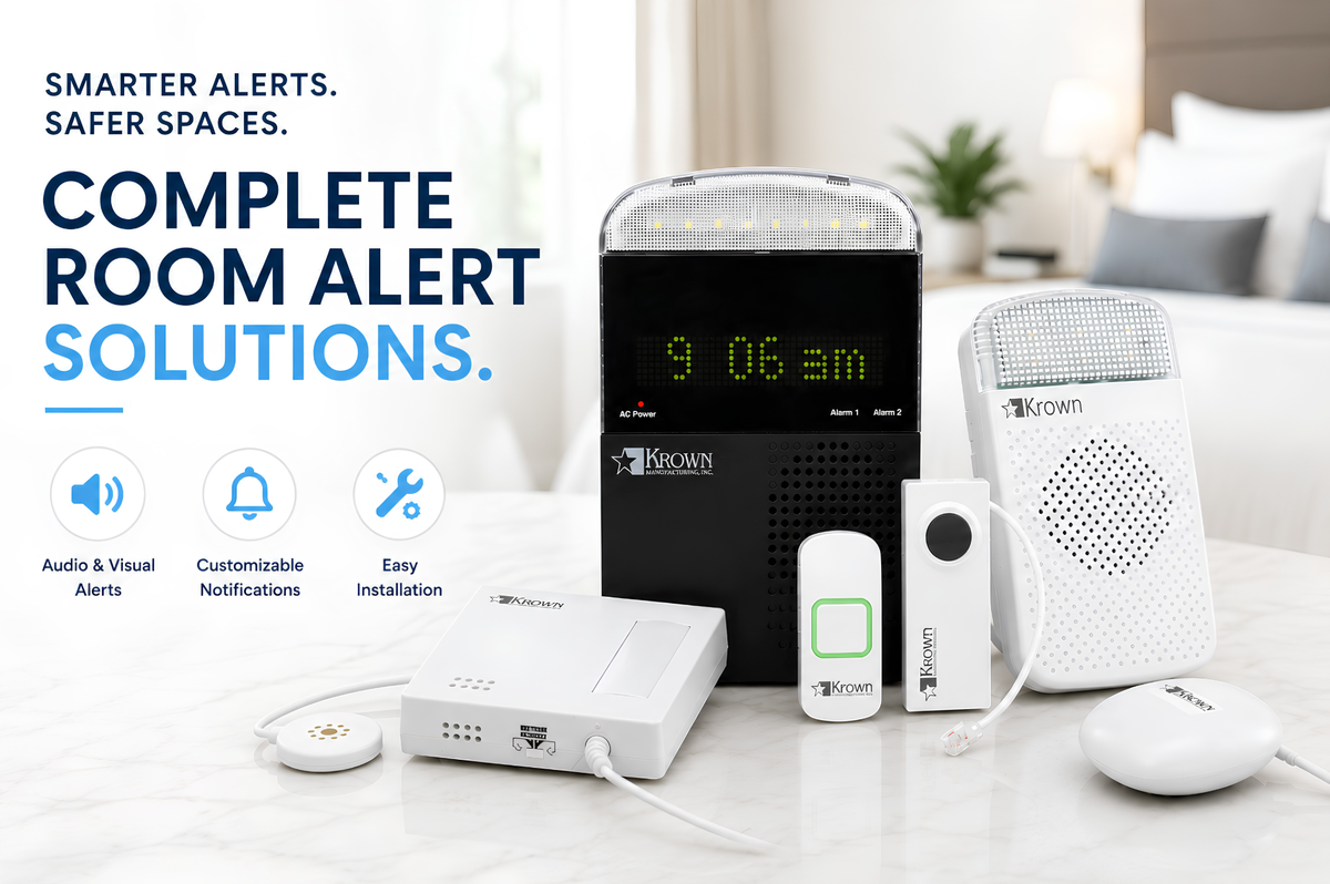 Krown LookOut™ room alert system on a bedside table: alarm clock receiver with strobe, wireless doorbell push button, telephone transmitter, sound monitor, and bed shaker. Smarter alerts, safer spaces — audio and visual alerts, customizable notifications, easy installation.